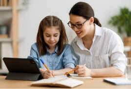 Mother and daughter working through some homework together