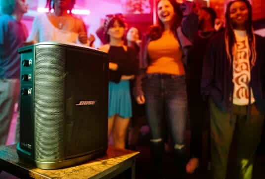 The Bose S1 Pro+ Wireless PA System plays music at a lively party.