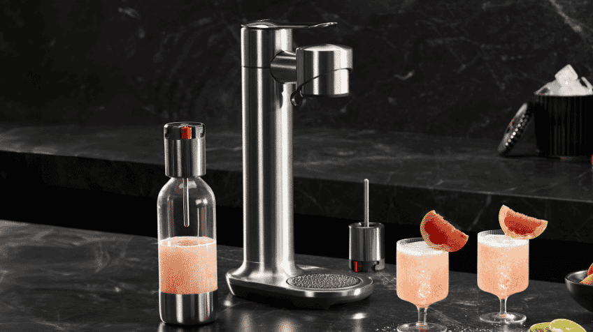 The Breville Fizz with bottle and fresh cocktails on black marble bench