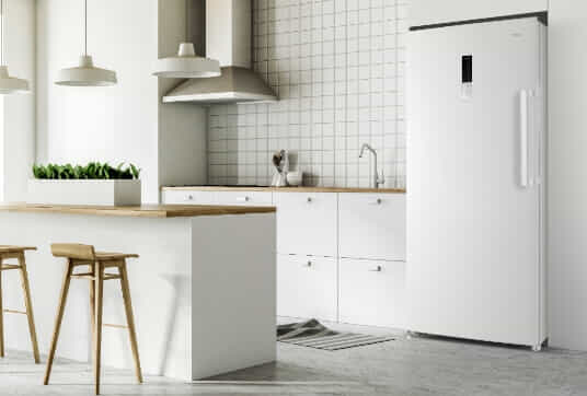 A white CHiQ fridge in a bright and airy white kitchen