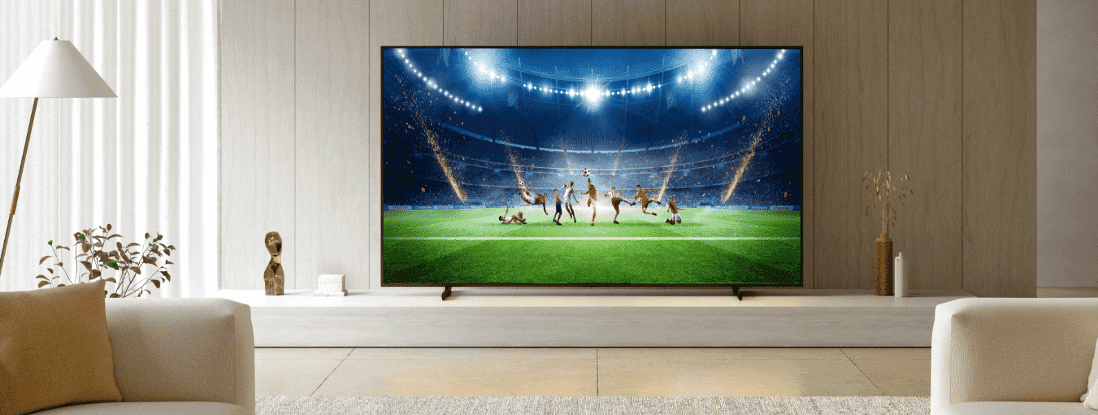 Sony X90L with football game on screen in chic light living room.
