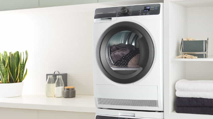 A Westinghouse dryer in a white laundry.