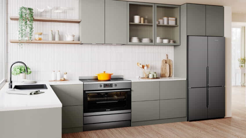 A Westinghouse freestanding oven in a white and sage green kitchen.