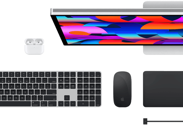 Top view of selected Mac accessories: Studio Display, Magic Keyboard, Magic Mouse, Magic Trackpad, AirPods and MagSafe charging cable