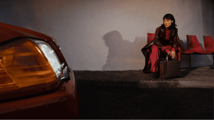 A woman sitting while wearing the Bose Quietcomfort Ultra Earbuds