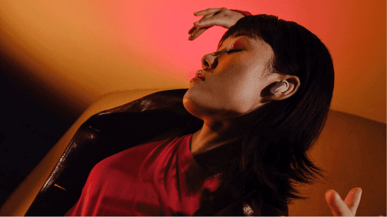 A woman dancing while wearing Bose Ultra earbuds