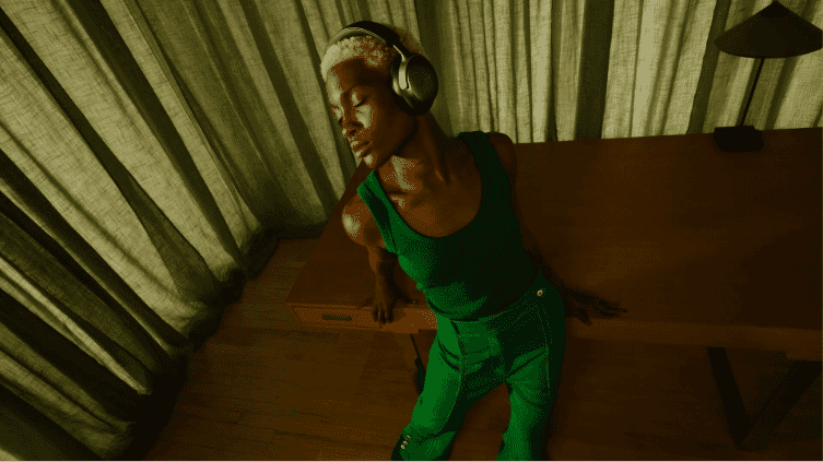 A woman sitting while wearing her Bose Quietcomfort Ultra Headphones