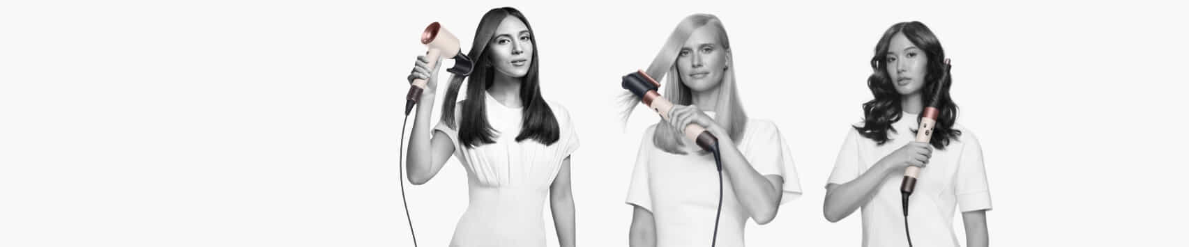 Three models hold a Dyson Hair Dryer and Dyson Airwrap in ceramic pink and rose gold