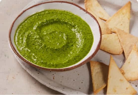 Nigella's coriander and jalapeno salsa in a bowl with corn chips to serve.