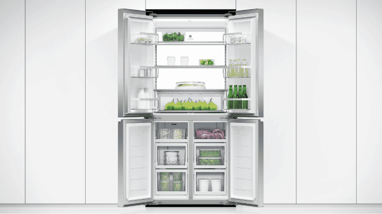 An open Quad Door Refrigerator in a pristine white kitchen