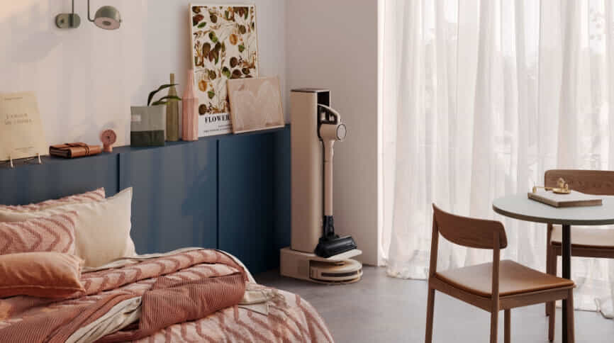 LG's two in one stick vacuum and robot vac in stylish bedroom.