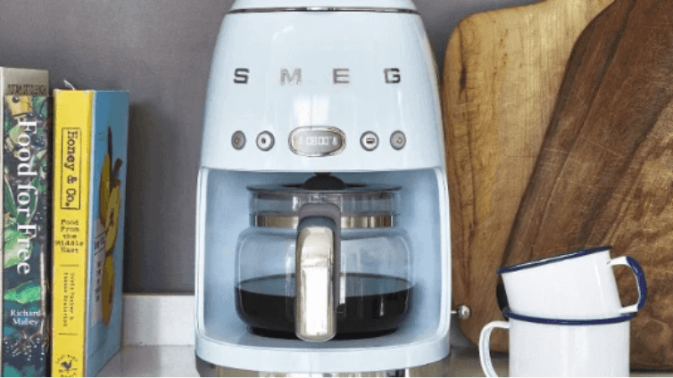 A smeg blue drip coffee machine in a modern home