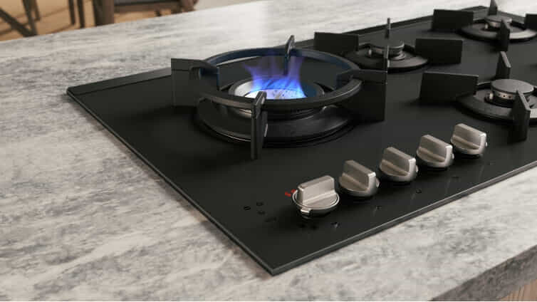 Side shot of ASKO Gas Cooktop on grey marble counter.