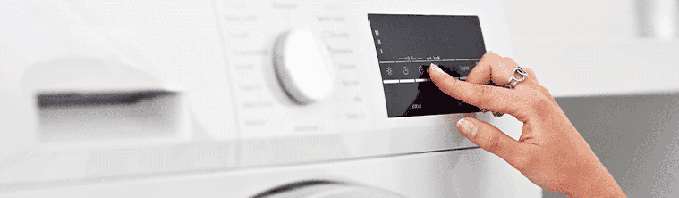 Close-up image of someone interacting with the touchscreen on a dryer