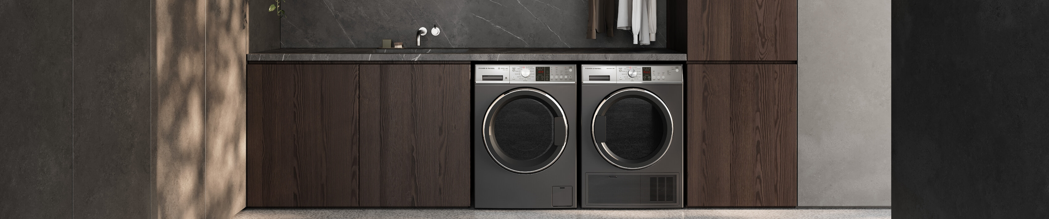 Lifestyle image of the Fisher & Paykel front load washing machine and heat pump dryer side by side in a modern laundry.