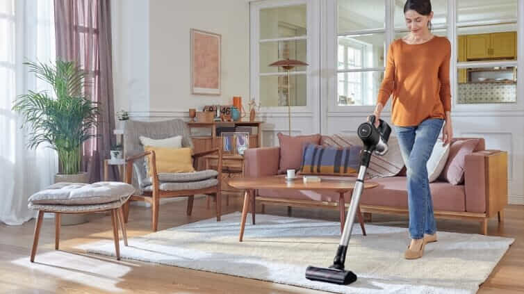 Woman vacuuming her home with the LG A9N-Prime.