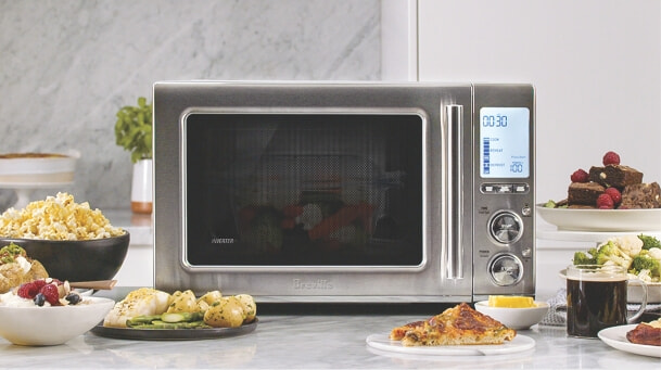 Combi oven by panasonic with food around it.