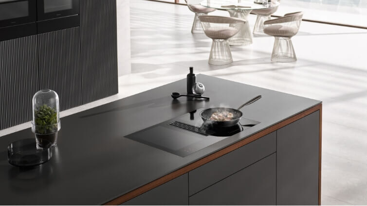 Miele Induction Cooktop on Black Countertop.