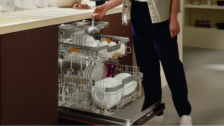 Man emptying Miele Dishwasher.