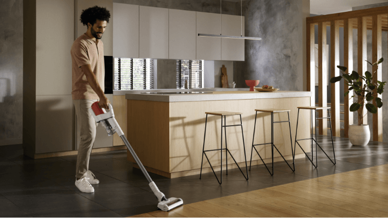 A man using the miele Duoflex Vacuum