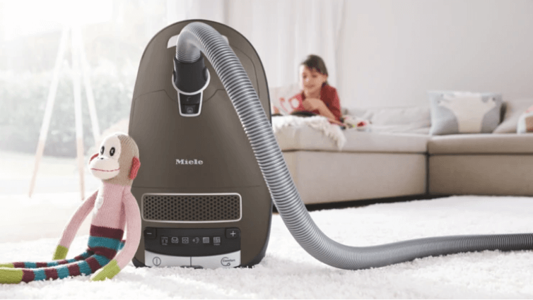 A Miele barrel vacuum in a childs room