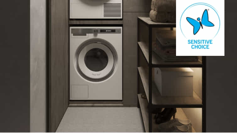 Front load ASKO washing Machine in moody laundry.