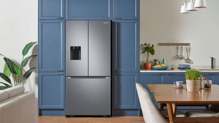 Stylish Samsung fridge with big freezer in blue kitchen.