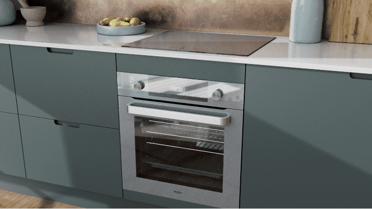 Down shot of grey Haier oven in teal coloured kitchen.