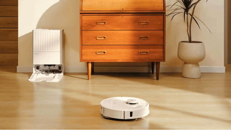 White Robot Vacuum cleaning hard floors.