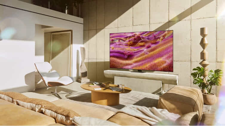 Stylish Samsung QLED TV in light coloured living room.