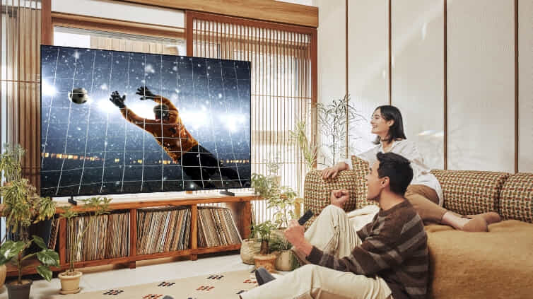 Couple watching sport on Samsung Crystal HD TV.