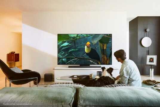 Man watching his new Samsung 2025 TV at home.