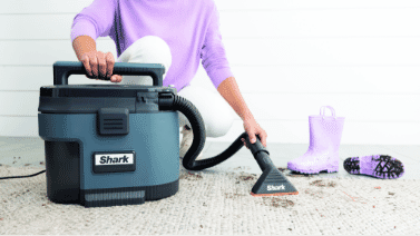 The Shark MessMaster portable wet/dry vacuum cleaning dirt off a countertop