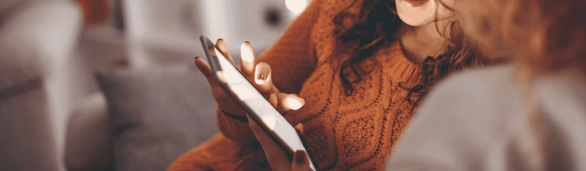 Close-up image of a woman using a tablet