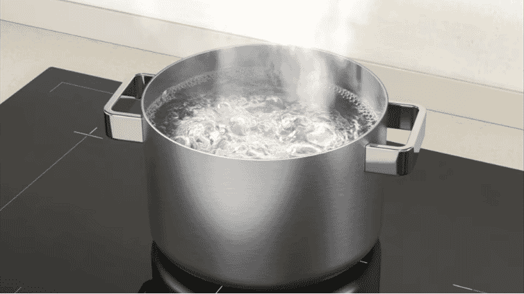 Close-up image of a pot boiling on a Westinghouse induction cooktop.