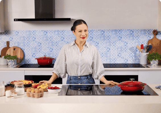 Image of Poh Ling Yeow standing in front of an LG induction cooktop.