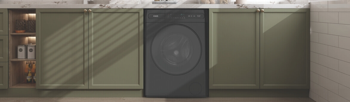 black washing machine in green laundry room