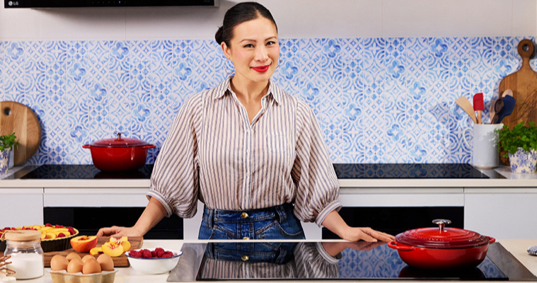 Image of Poh Ling Yeow standing behind an LG Induction Cooktop