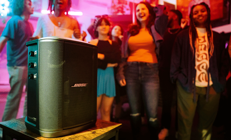 The Bose S1 Pro+ Wireless PA System plays music at a lively party.