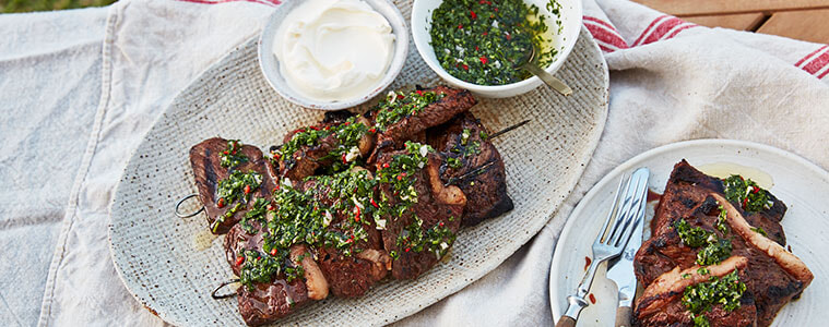 Chimichurri Beef Skewers with dip on a picnic blanket
