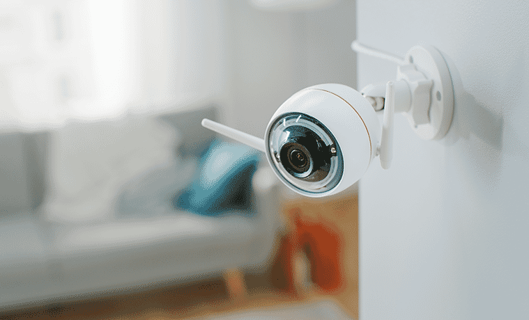 Close up shot of a wall-mounted indoor security camera. 