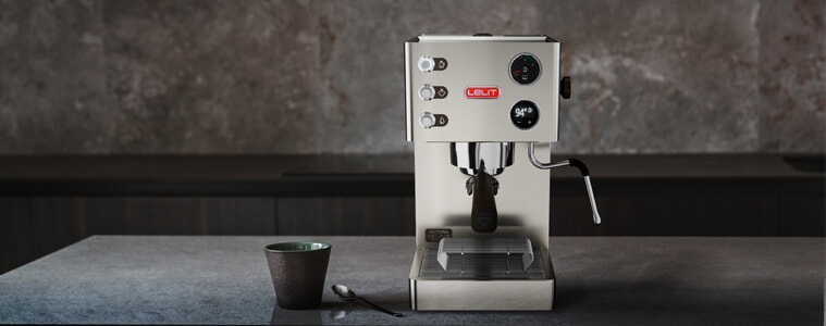 A Lelit Victoria coffee machine sits on a grey benchtop in a kitchen.