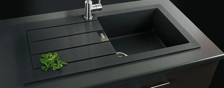A black Tectonite sink with a silver tap.