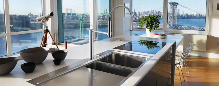 A chrome swivel mixer tap in a sleek modern apartment.