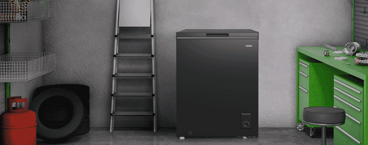 A black CHiQ freezer sits in a garage.