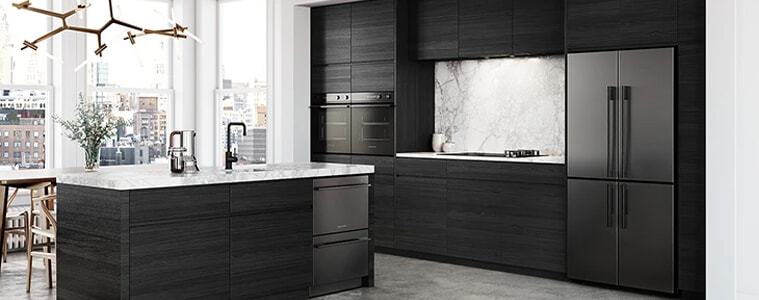 A black timber kitchen with white countertops and black appliances.
