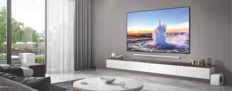 A UHD TV is mounted on a wall in a sleek modern living room.