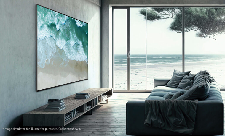 A large TV mounted to the wall of a neutral toned modern living room by the beach.
