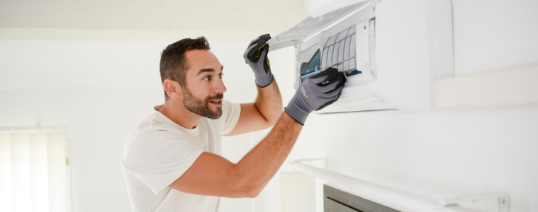 man cleaning aircon