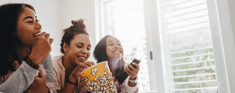 Friends in bedroom watching TV